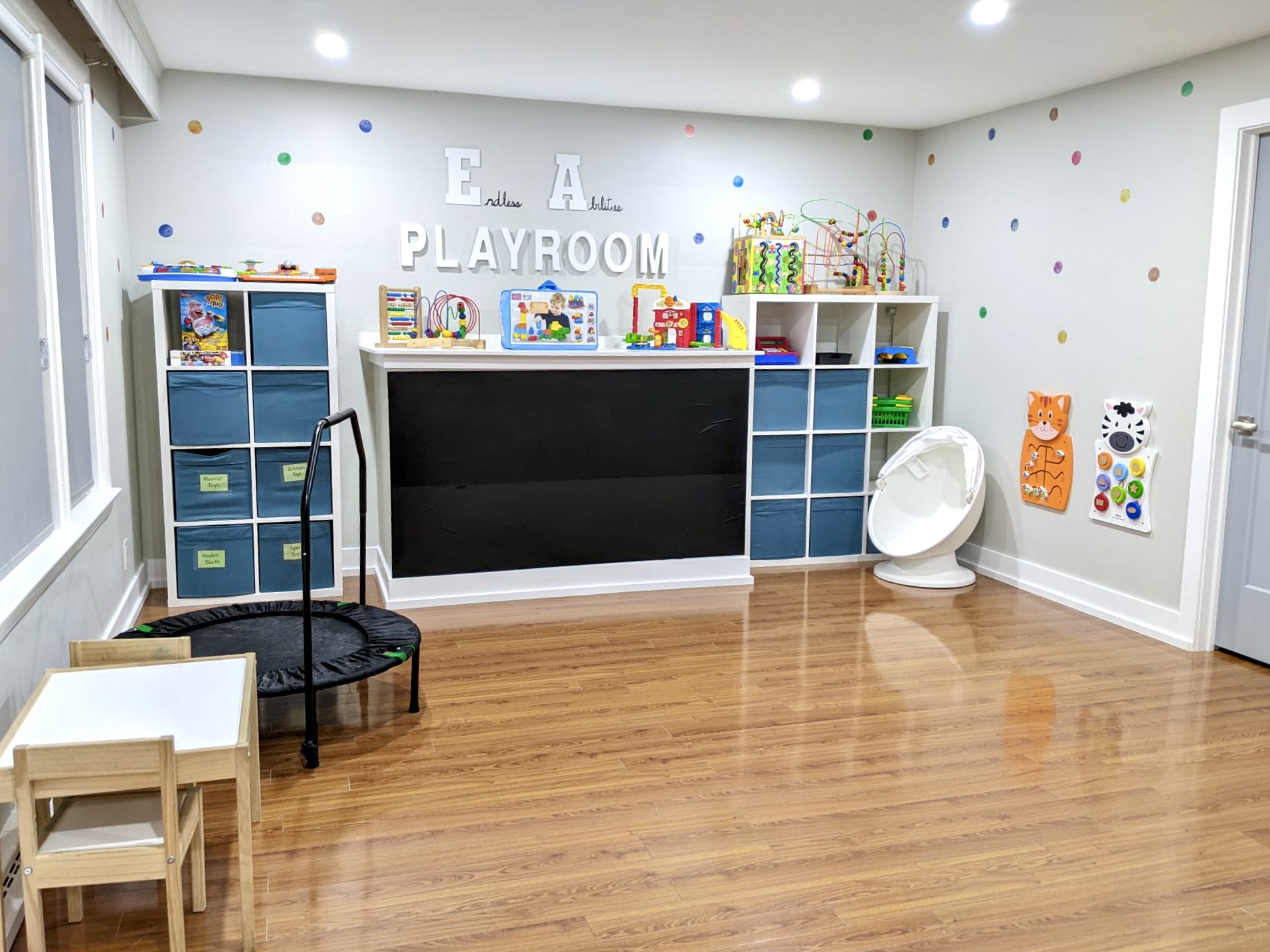 A tidy child's playroom with toys neatly stored.