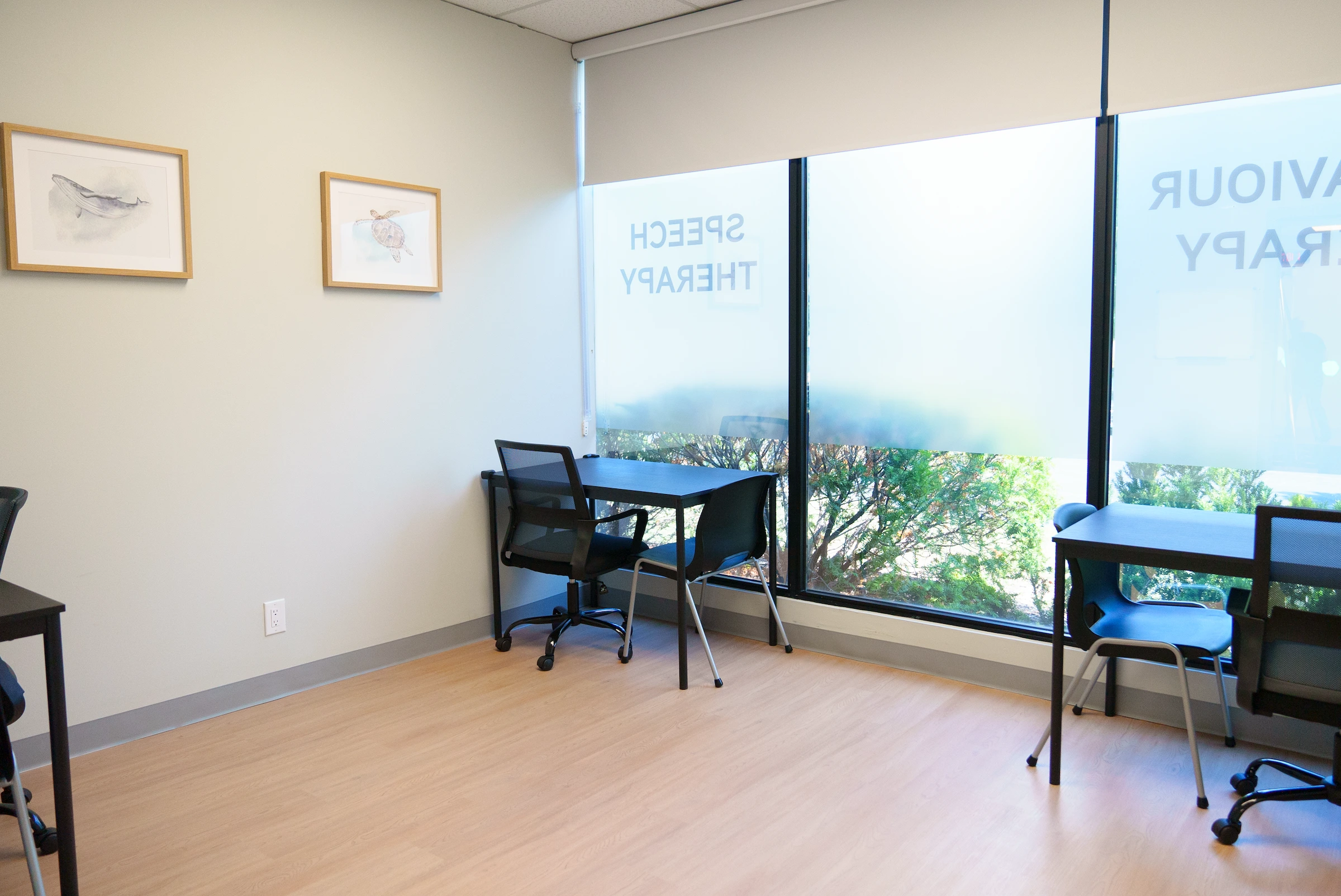 An assessment room with tables and chairs.