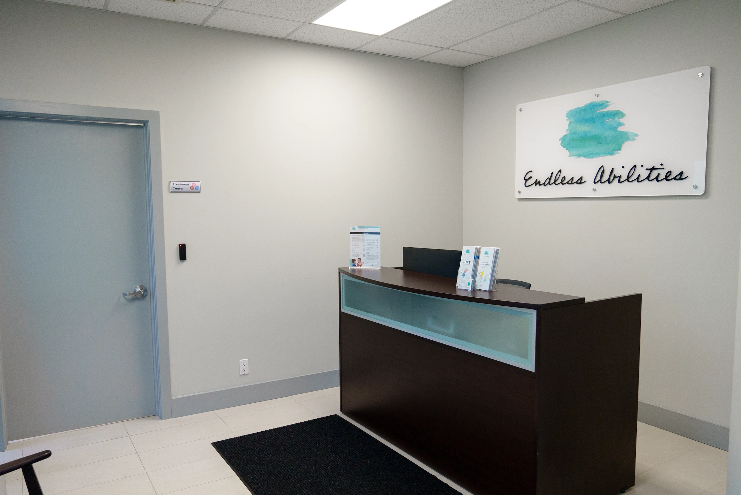 A reception area with a desk and sign.